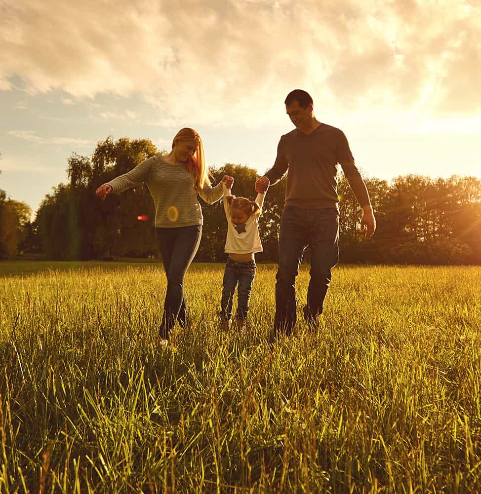 family-walking-toward-sunset-mobile - Veritas Fertility & Surgery